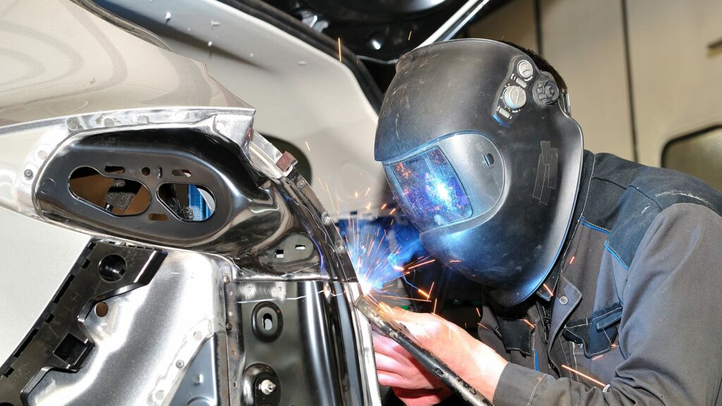 Mechanic welding car body panels